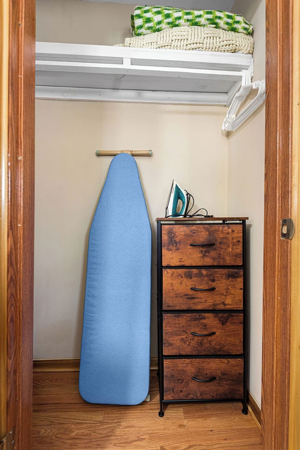 We store the baby high chair, iron, and ironing board in this room's closet.