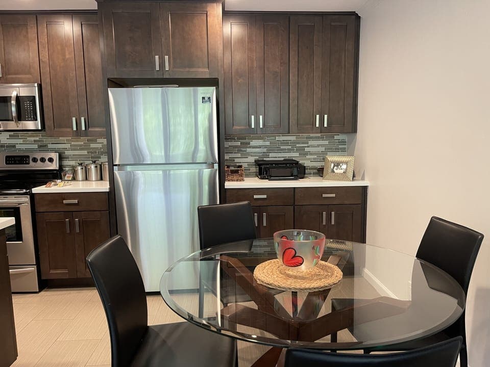Fully equipped modern kitchen with a nice dining table setup 