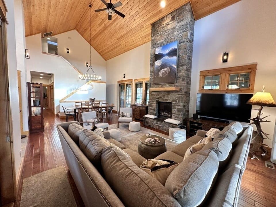 Large living space with fireplace, TV and formal dining