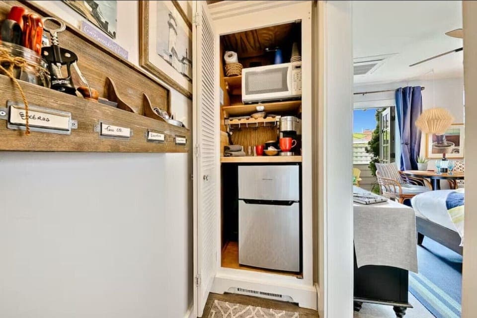 Kitchenette area with a mini fridge, microwave, and Keurig