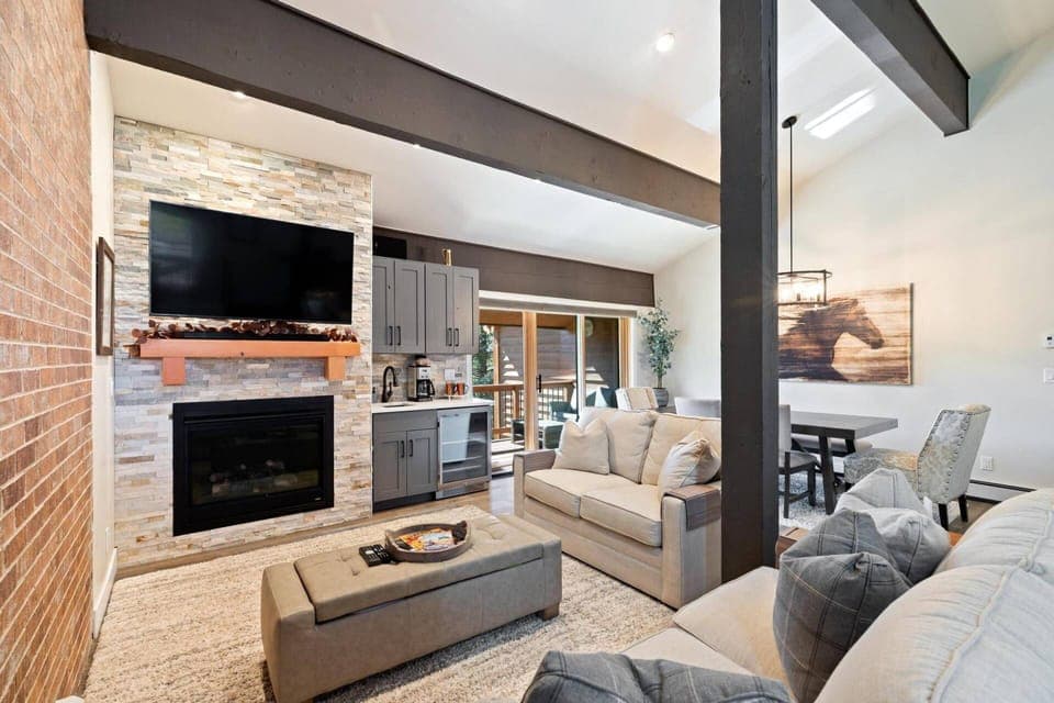 Cozy living room with a warm fireplace and flat-screen TV—perfect for relaxing after a day in the mountains!