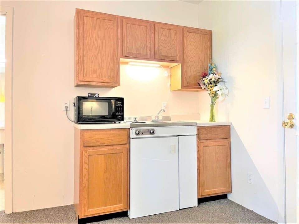 Kitchenette with Sink, Microwave, Range, Fridge and Freezer.  Stocked with pans, flatware, silverware and other ammenities.