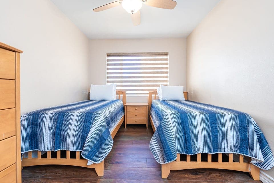 The fourth guest bedroom, located upstairs, includes two inviting twin-size beds
                