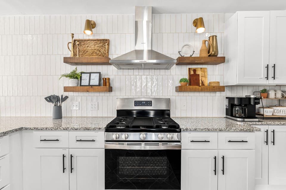 In this stunning kitchen, the white cabinets beautifully contrast with the sleek black stove. 😍✨ Get inspired to cook your favorite meals!