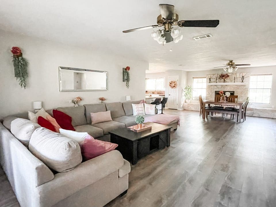 Jumbo couch and open concept floor plan with views of dining and kitchen.