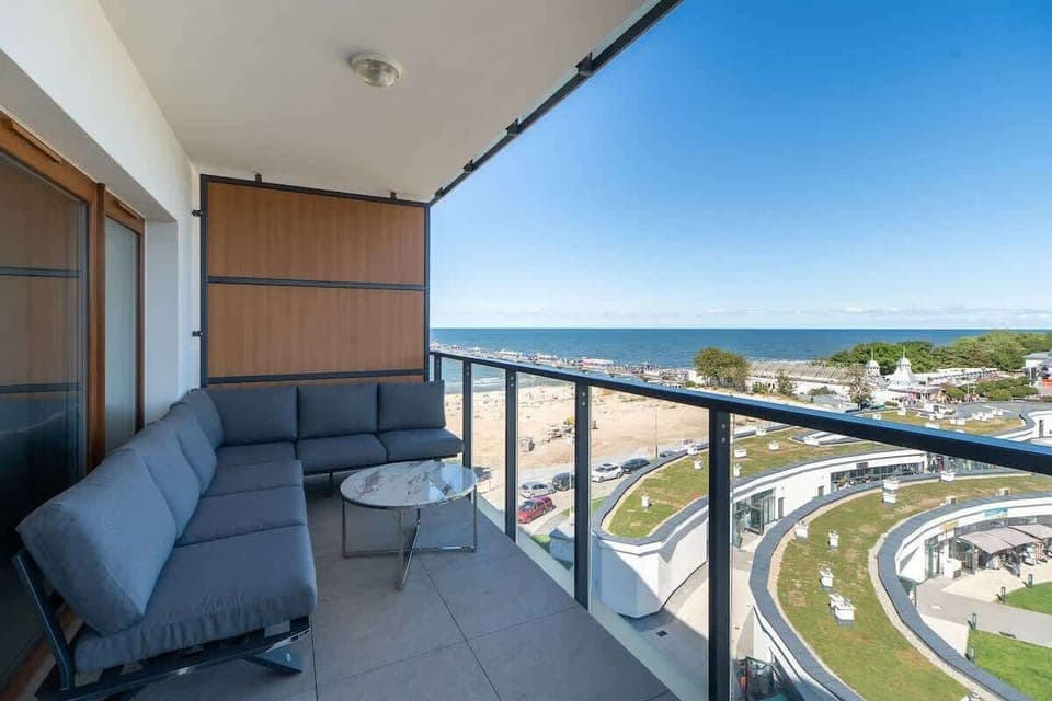 A spacious balcony with a comfortable seating area and a scenic view of the surroundings, perfect for relaxation.
