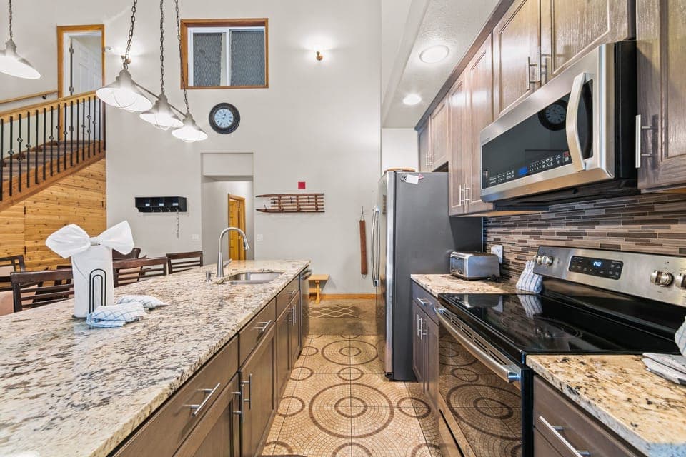 Updated kitchen with granite countertops and stainless steel appliances.