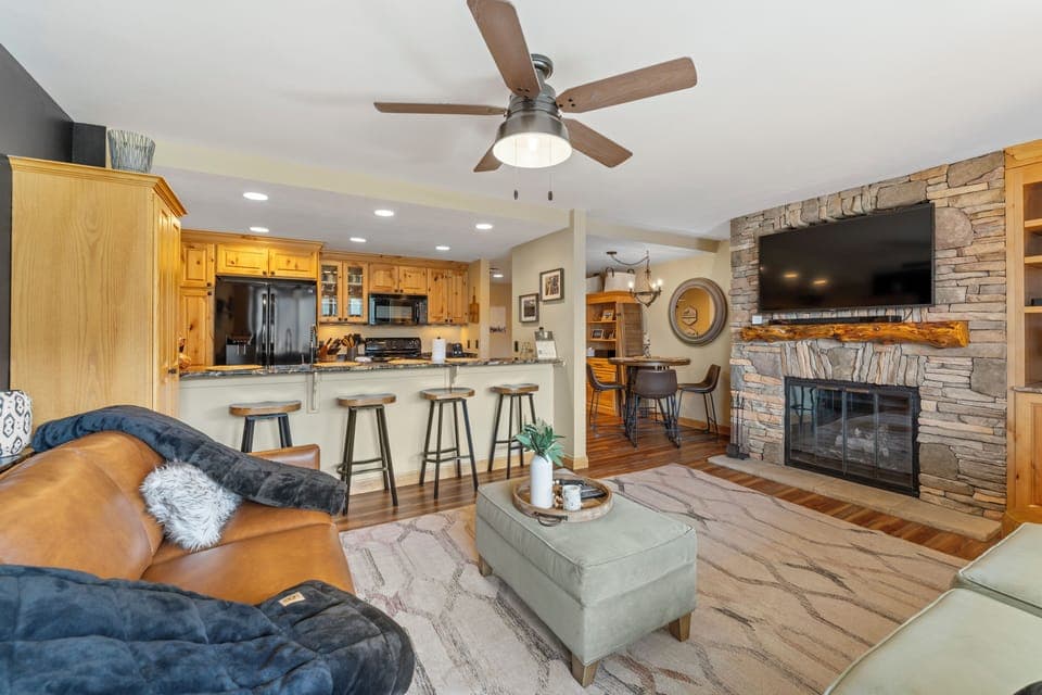 Living area with pull out sofa bed, TV, and balcony access.