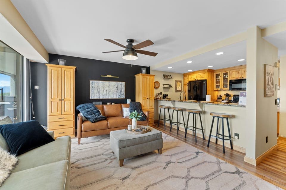 Living area with pull out sofa bed, TV, and balcony access.
