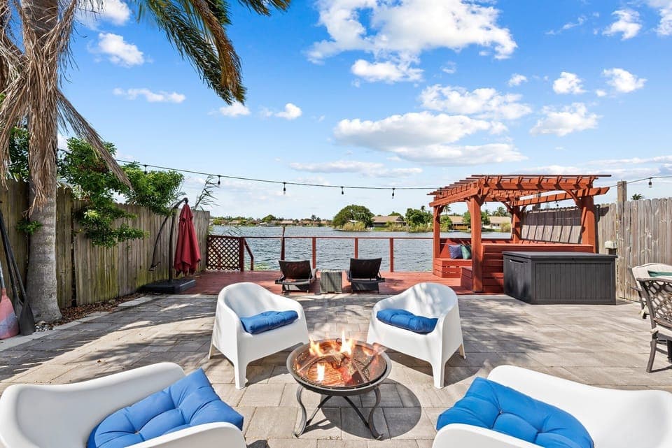 Outdoors featuring Patio with firepit, sun loungers, cabana, and hot tub