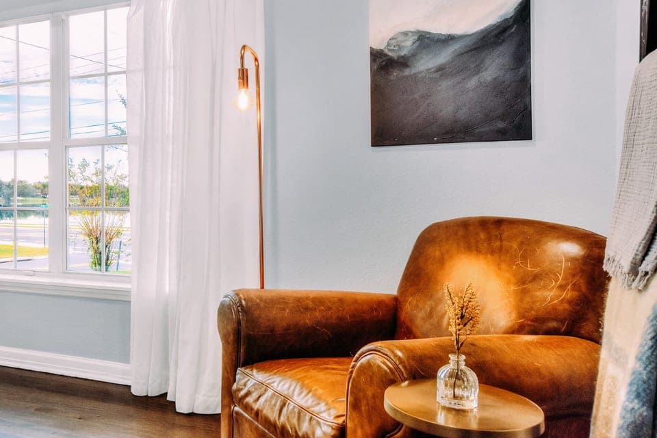 This vintage leather chair completes the reading nook in the Elby Great room