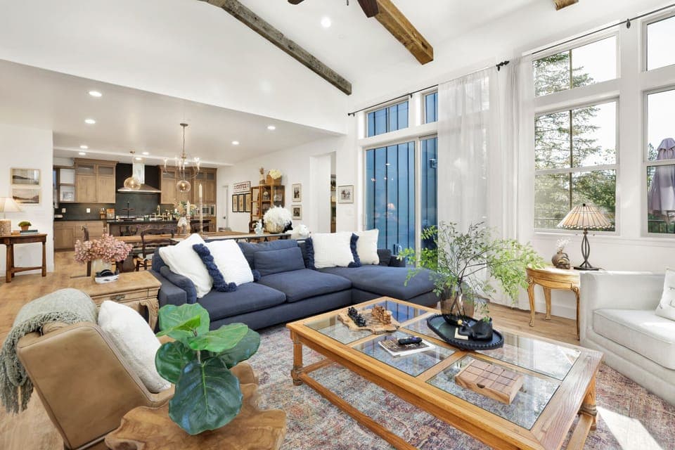 Cozy mountain living room with a fireplace, comfy seating, and smart TV—perfect for relaxing evenings, movie nights, and warm cabin vibes after outdoor adventures.