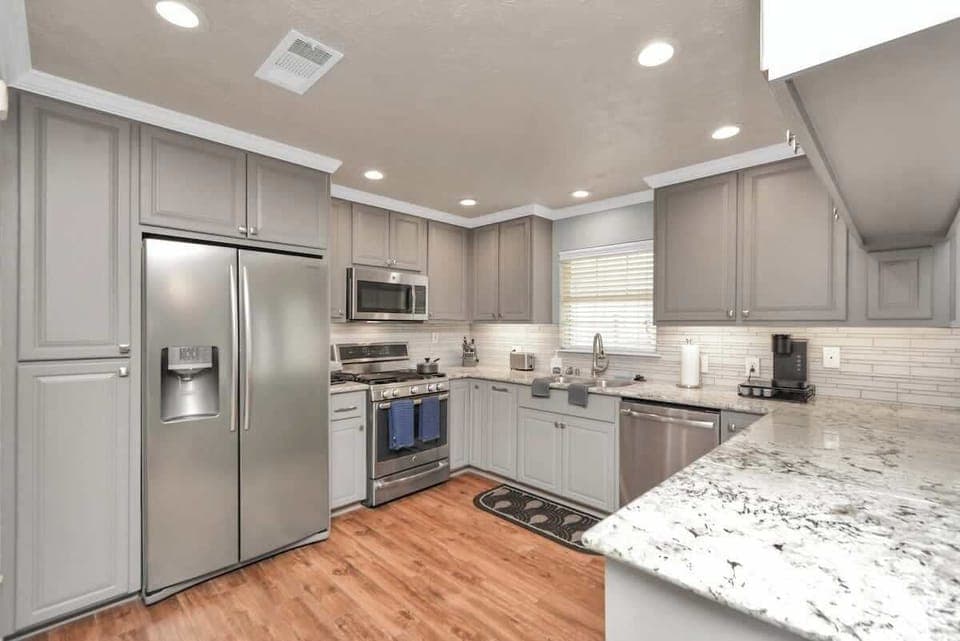 Welcome to our beautiful and spacious kitchen featuring brand new stainless appliances! It's the perfect space to whip up your favorite meals and create delicious memories!
